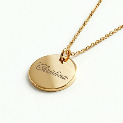 Gold necklace with a round pendant engraved with 'Christina' on a white background