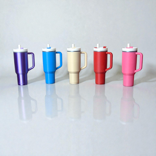 Five colorful chapstick holders shaped as travel mugs with lids on a white surface