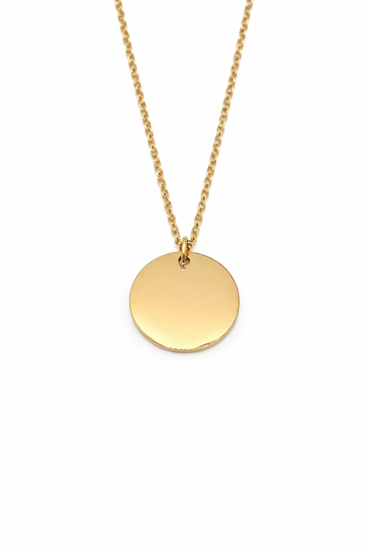 Gold necklace with a round pendant on a white background