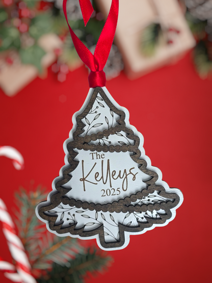 Decorative Christmas tree ornament with 'The family name 2025' text on a red background.