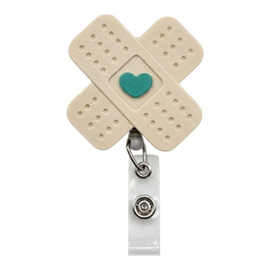 Beige bandage-shaped badge holder with a teal heart on a white background