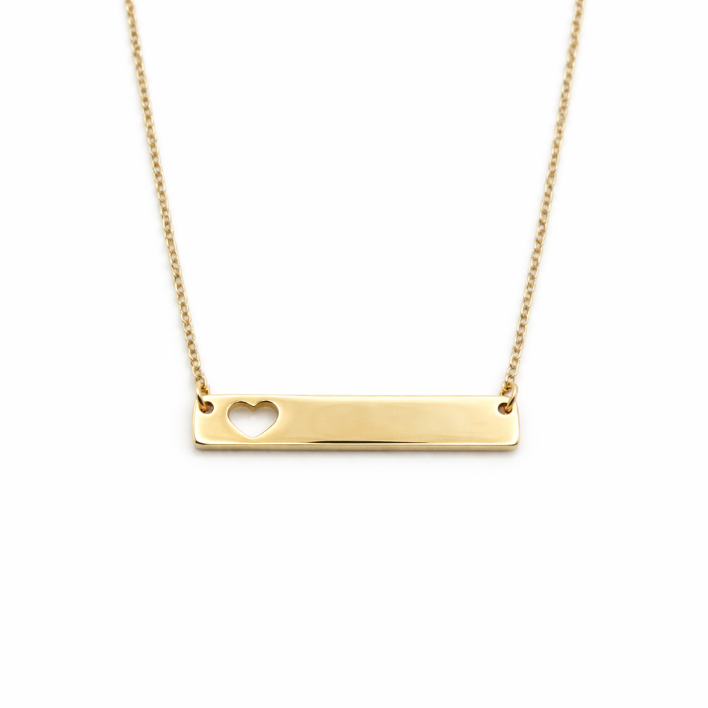 Gold necklace with a heart cutout on a white background