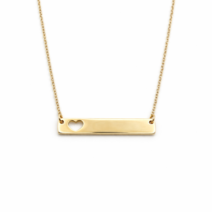 Gold necklace with a heart cutout on a white background