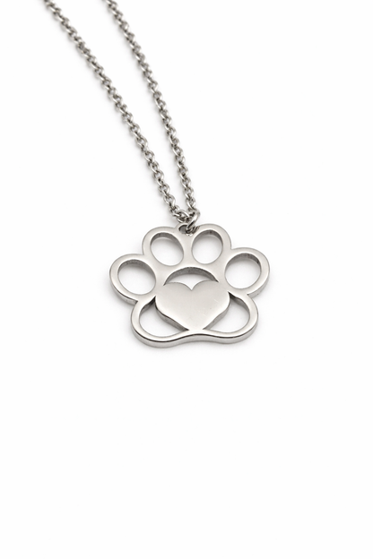 Silver paw print necklace with a heart on a white background